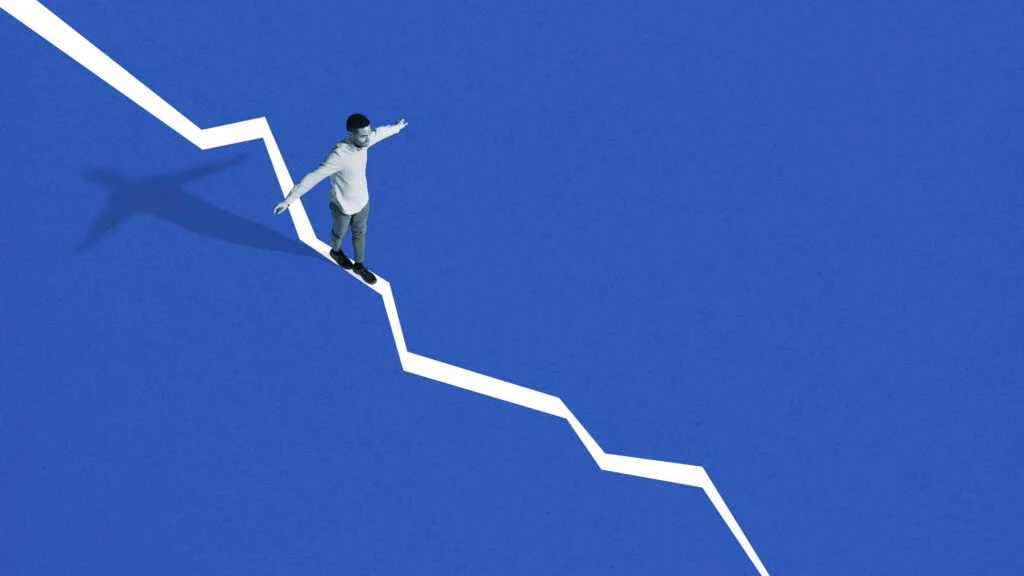 A young man balancing with his arms outstretched on a white line that steps steadily downward across a deep blue field.
